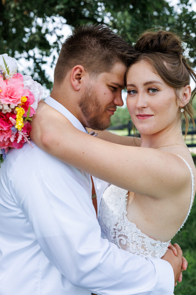 Outdoor wedding venue at Pleasant Pastures Events in Central MN featuring giant oak trees, ponds, outdoor ceremony site, reception tent, concrete dance floor, grain bin bar, garden like setting, rustic outdoor