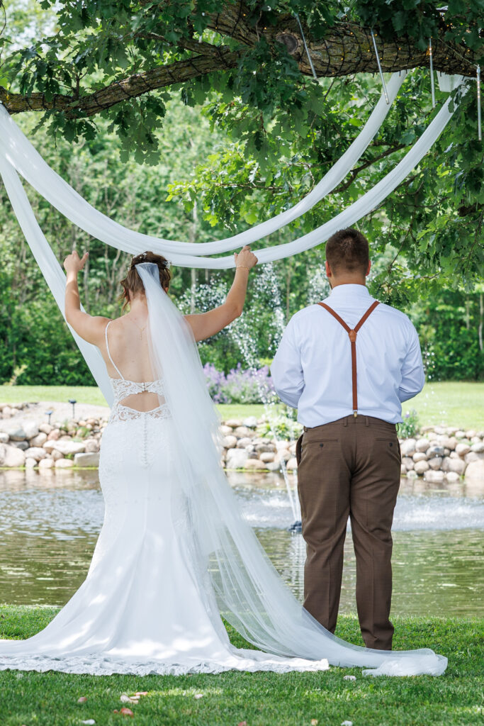 Outdoor wedding venue at Pleasant Pastures Events in Central MN featuring giant oak trees, ponds, outdoor ceremony site, reception tent, concrete dance floor, grain bin bar, garden like setting, rustic outdoor