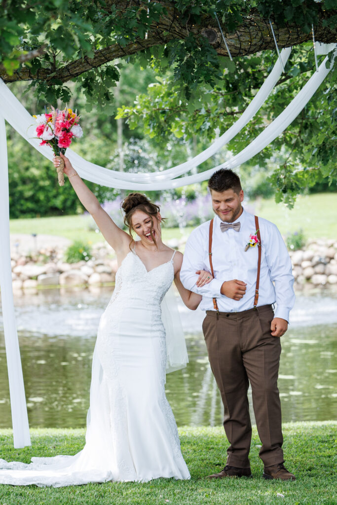 Outdoor wedding venue at Pleasant Pastures Events in Central MN featuring giant oak trees, ponds, outdoor ceremony site, reception tent, concrete dance floor, grain bin bar, garden like setting, rustic outdoor