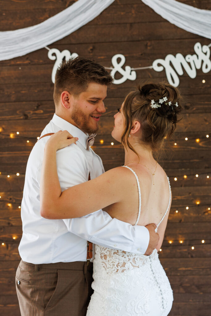 Outdoor wedding venue at Pleasant Pastures Events in Central MN featuring giant oak trees, ponds, outdoor ceremony site, reception tent, concrete dance floor, grain bin bar, garden like setting, rustic outdoor