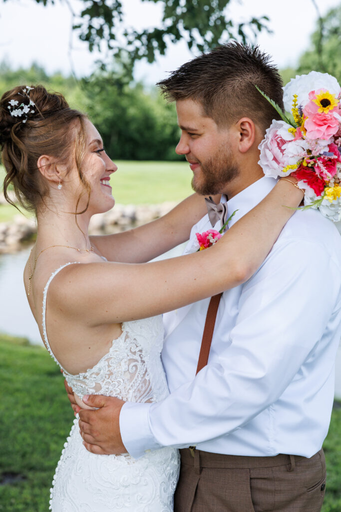 Outdoor wedding venue at Pleasant Pastures Events in Central MN featuring giant oak trees, ponds, outdoor ceremony site, reception tent, concrete dance floor, grain bin bar, garden like setting, rustic outdoor