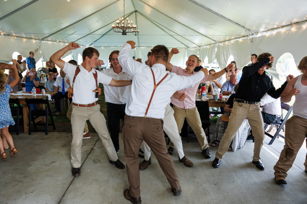 Outdoor wedding venue at Pleasant Pastures Events in Central MN featuring giant oak trees, ponds, outdoor ceremony site, reception tent, concrete dance floor, grain bin bar, garden like setting, rustic outdoor