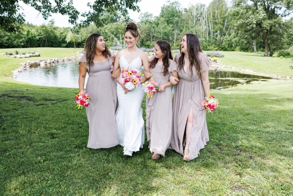 Outdoor wedding venue at Pleasant Pastures Events in Central MN featuring giant oak trees, ponds, outdoor ceremony site, reception tent, concrete dance floor, grain bin bar, garden like setting, rustic outdoor