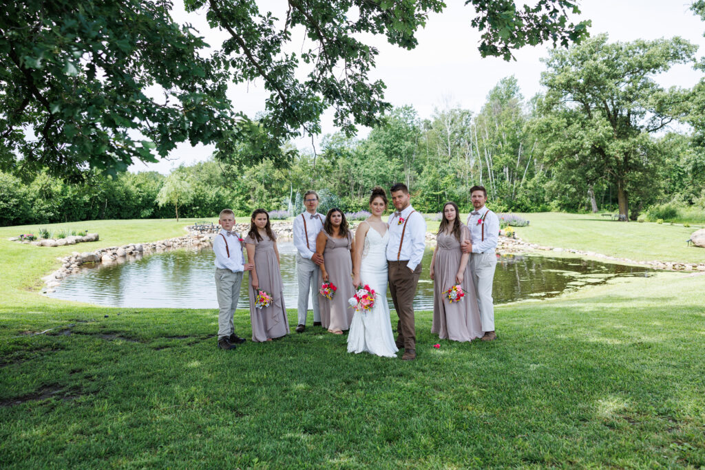 Outdoor wedding venue at Pleasant Pastures Events in Central MN featuring giant oak trees, ponds, outdoor ceremony site, reception tent, concrete dance floor, grain bin bar, garden like setting, rustic outdoor