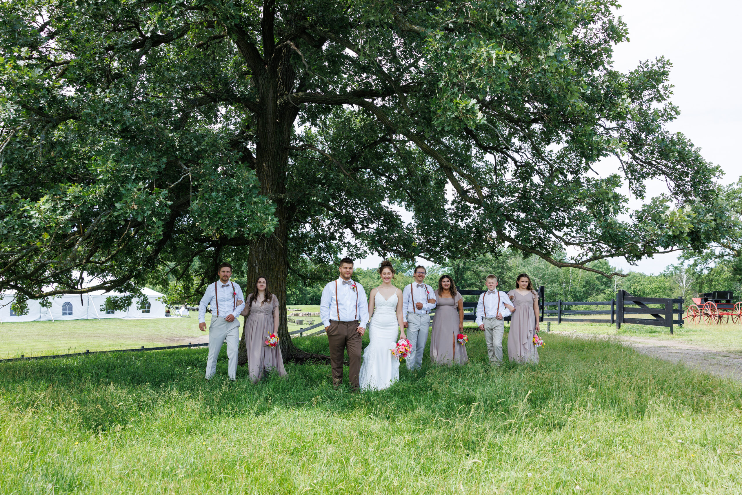 Outdoor Wedding Venue at Pleasant Pastures Events in Central MN featuring pond, oak tree, outdoor ceremony site, reception tent, grain bin bar, for engaged couples